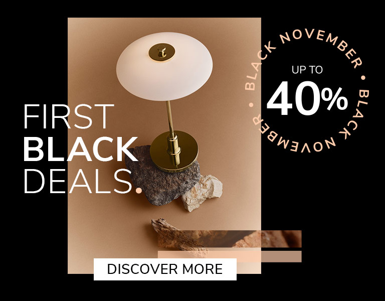 Elegant designer table lamp on natural stone base with gold stem and white shade, promoting Black November sale – up to 40% off with text ‘First Black Deals’ and ‘Discover More’ button.