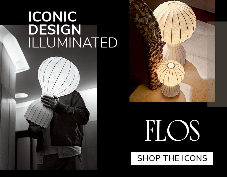 Designer holding illuminated Flos lamp with sculptural paper shade, alongside glowing floor lamps in warm tones, promoting ‘Iconic Design Illuminated’ and ‘Shop the Icons’ campaign.